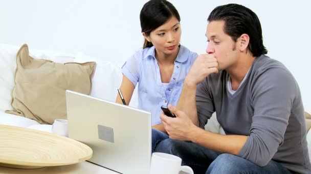 Couple using laptop and smartphone — Stock Video