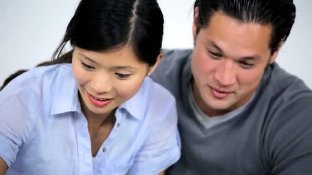 Asian couple at home using laptop — Stock Video