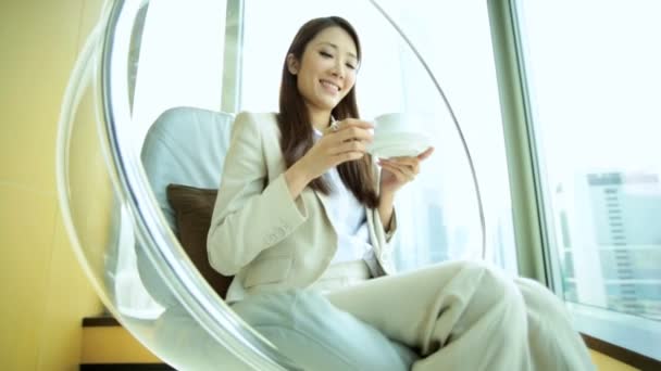 Woman drinking coffee in chair — Stock Video