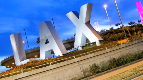 LAX sign dusk traffic International Airport Los Angeles USA — Stock Video