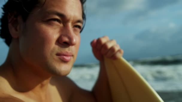 Uomo che tiene tavola da surf sulla spiaggia — Video Stock