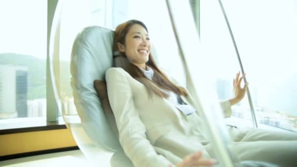 Asian woman relaxing in chair — Stock Video