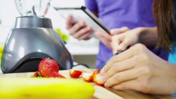 Couple prepare fresh healthy organic fruit smoothie — Stock Video