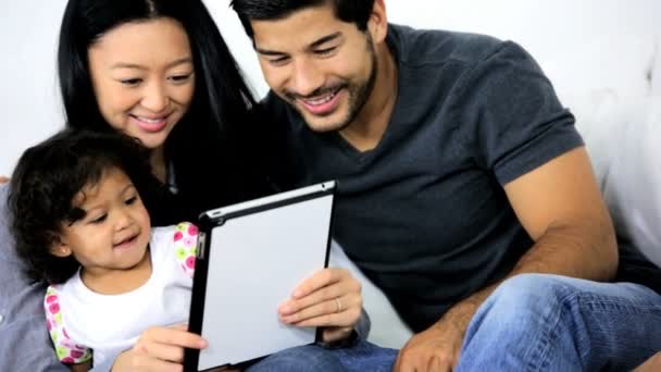 Girl playing on tablet with parents — Stock Video