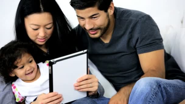 Girl playing on tablet with parents — Stock Video