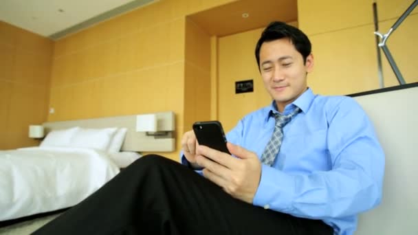 Businessman in hotel using smartphone — Stock Video