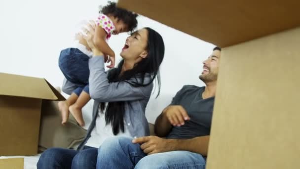 Couple on sofa playing with daughter — Stock Video