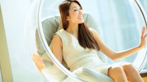 Laughing woman in bubble chair — Stock Video