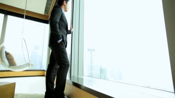 Businessman in hotel viewing cityscape — Stock Video