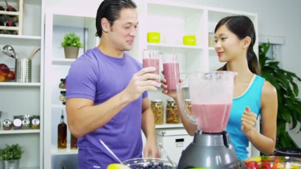 Couple enjoying delicious organic fruit smoothie — Stock Video