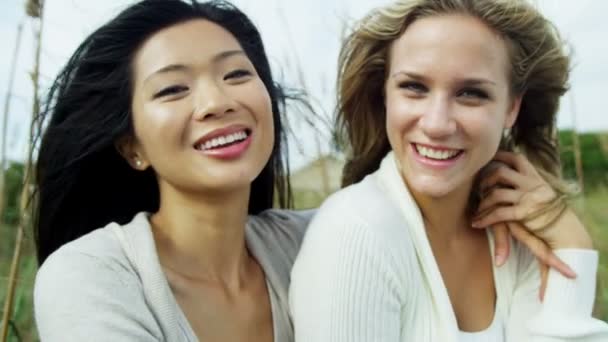 Mujeres sonrientes disfrutando de vacaciones en la playa — Vídeo de stock