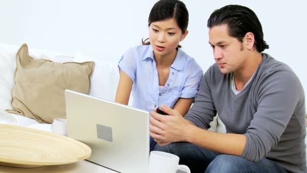 Couple using laptop and smartphone — Stock Video