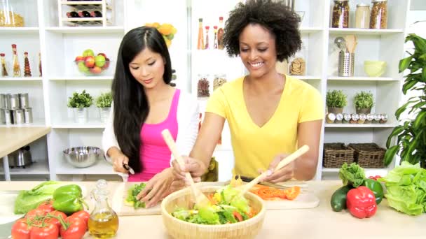 Girlfriends cutting fresh salad at kitchen — Stock Video