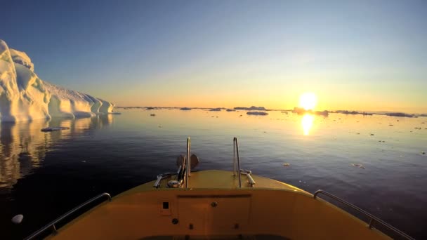 Barco flutuando no oceano com icebergs derretendo — Vídeo de Stock