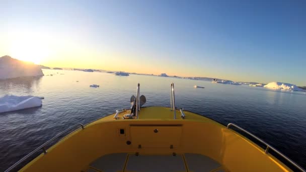 Barco flotando en el océano con icebergs derretidos — Vídeo de stock