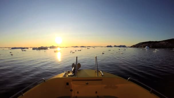 Barco flotando en el océano con icebergs derretidos — Vídeos de Stock