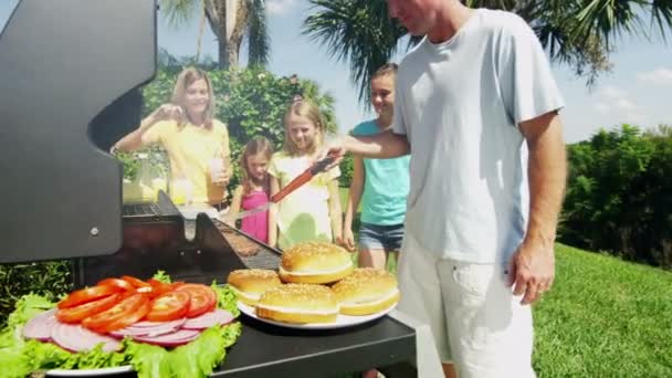 Parents with daughters grilling barbecue meat — Stock Video