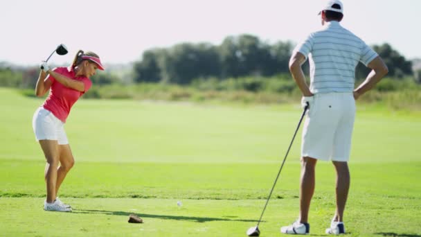 man and woman playing golf