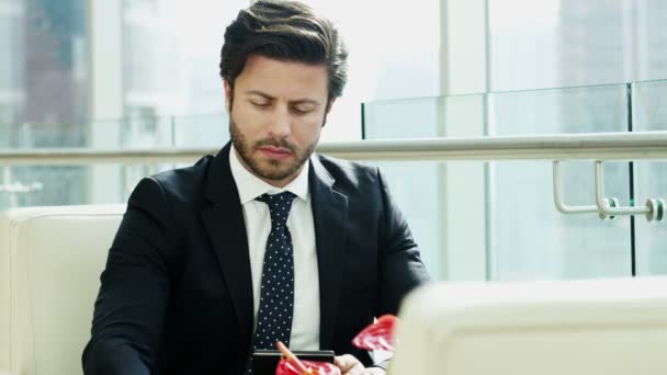 Businessman using digital tablet and drinking coffee — Stock Video