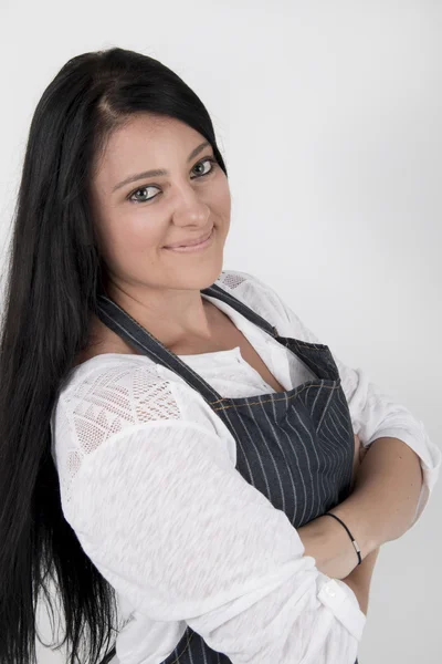 Young female wearing a blue strip, apron, smiling — Stock Photo, Image