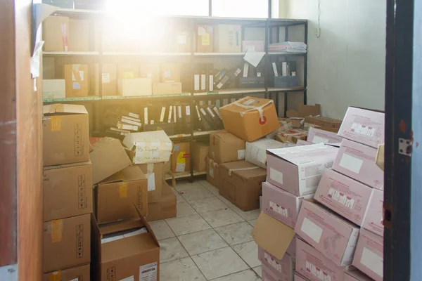 The old, cluttered archives, only sunlight shone through the box-filled room.