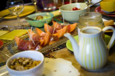 Meyve ve şampanyayla kaplı kahvaltı masası.