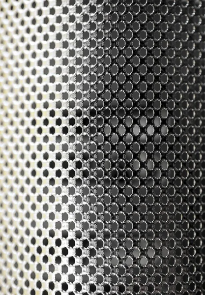 Metallic shiny surface of a stainless steel sieve
