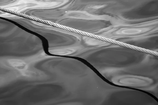 Thick ship rope on water — Stock Photo, Image