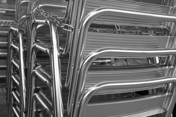 Aluminum chairs bonded by chain — Stock Photo, Image