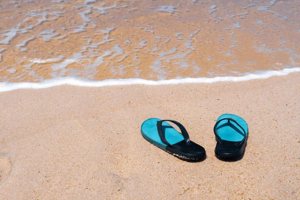 stock image Slippers on the sand at the sea with space , summer holiday and vacation concept.