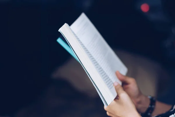 A person is reading book in car feel relax and peaceful environment background.