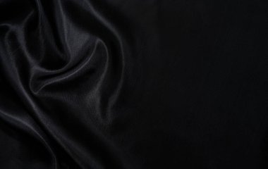 Sanat eserlerinin arka planı ve dekorasyonu için kumaşın koyu kumaş dokusunun bir parçası, güzel buruşmuş ipek ya da keten deseni. Buruşuk bir kumaş parçası.