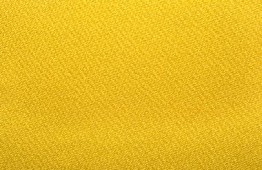 Kumaş. Terzilik malzemeleri, mobilya aksesuarları tasarımı. Doğal kumaştan yapılmış sarı arkaplan. Sarı altın keten kumaş dokusu arka plan, doğal tekstil deseni.