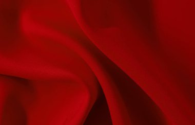 Kumaş. Malzeme. Öküzlü kırmızı kumaşın arka planı. Buruşuk kumaş