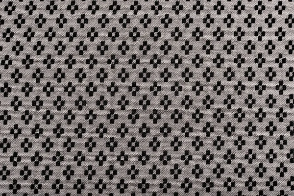 Kumaşın arka planında küçük bir desen var. Terzi, terzi ve elbise dikmek için moda tasarımcısı malzemesi. Doku. Desen