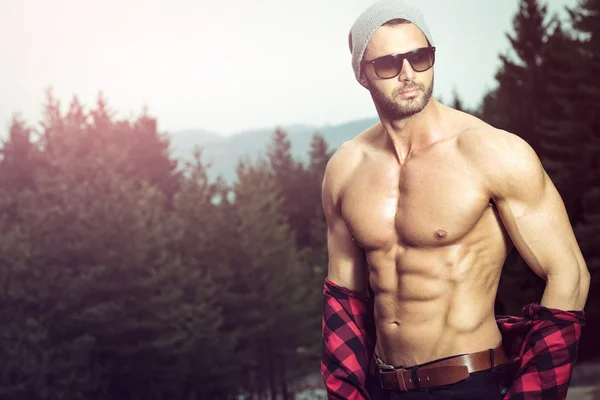 Handsome man wearing checked shirt outdoors — Stock Photo, Image