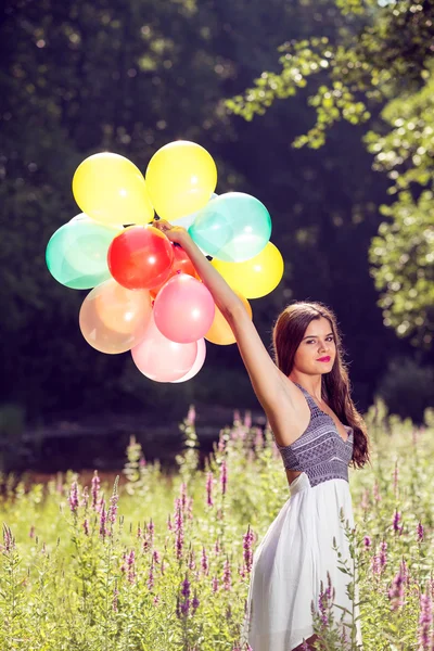 Chica sosteniendo globos en la mano —  Fotos de Stock