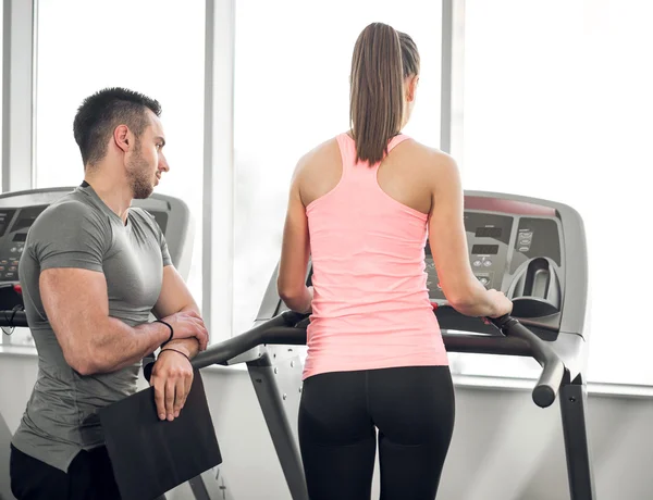 Treadmill walk with personal trainer. — Stock Photo, Image