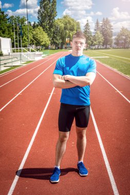 Atletik adam açık havada poz.