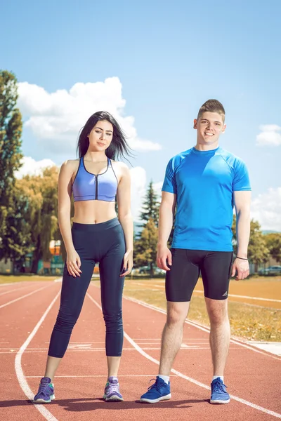 Two young athletes on track field.