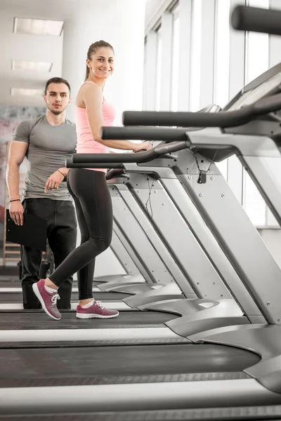 Treadmill walk with personal trainer. — Stock Photo, Image