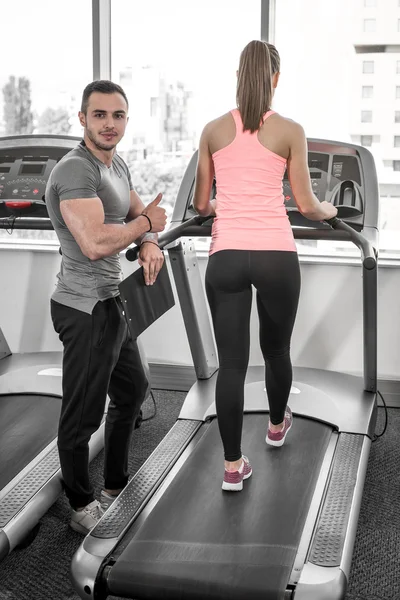 Treadmill walk with personal trainer. — Stock Photo, Image