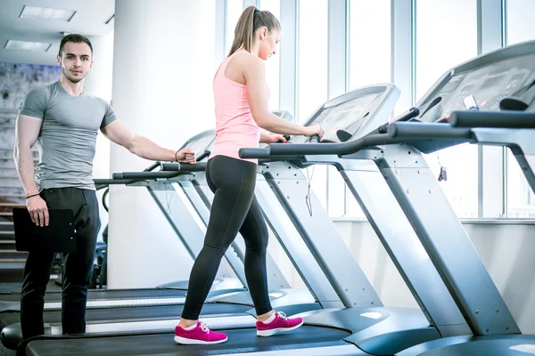Treadmill walk with personal trainer. — Stock Photo, Image
