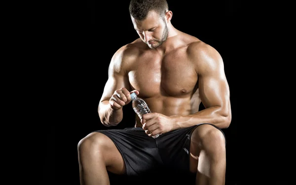 Чоловік п'є воду в спортзалі — стокове фото