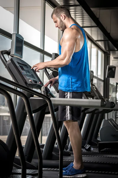 Man setting treadmill — Stock Photo, Image