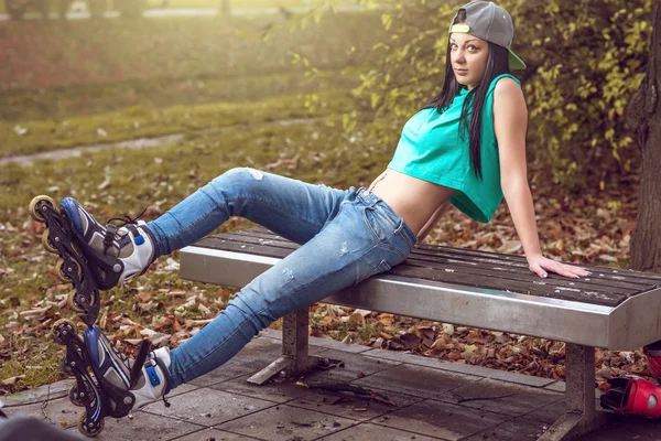 Rullen flicka poserar på parkbänk — Stockfoto
