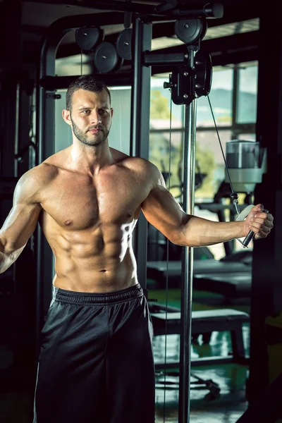 Man doing cable fly in gym — Stock Photo, Image