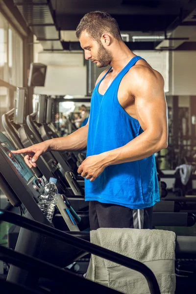 Man setting treadmill — Stock Photo, Image