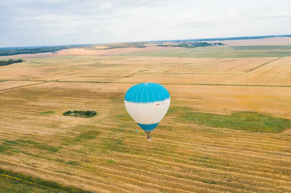 Hot air balloon flight over the fields.
