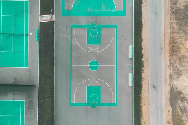 Basketball field aerial view on day time. Sport court above view from drone